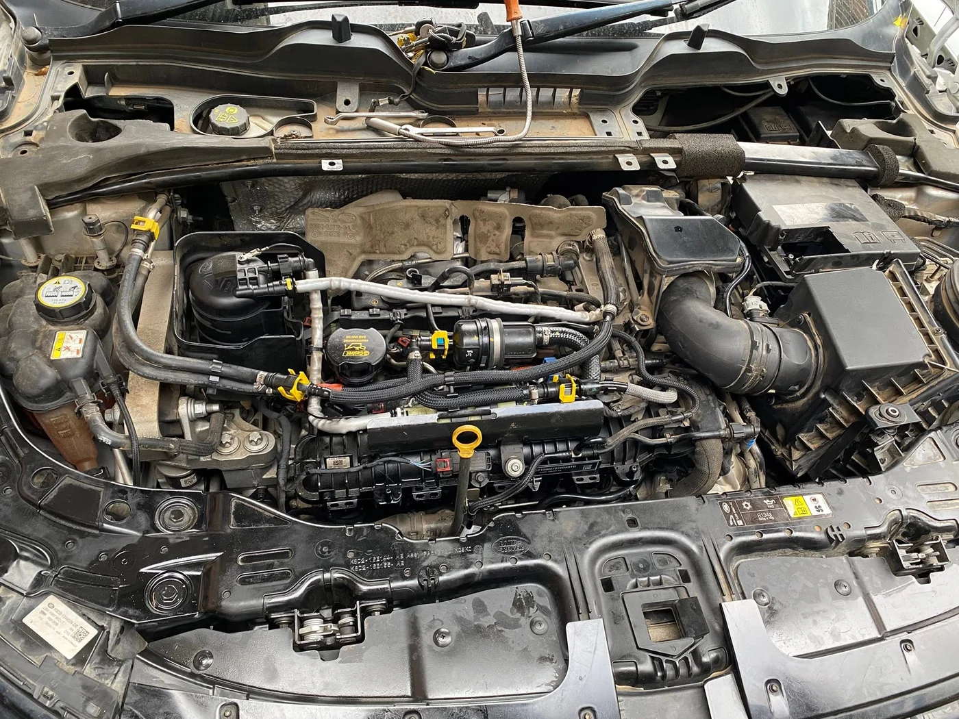 A wide view of an open engine bay during on-site vehicle work